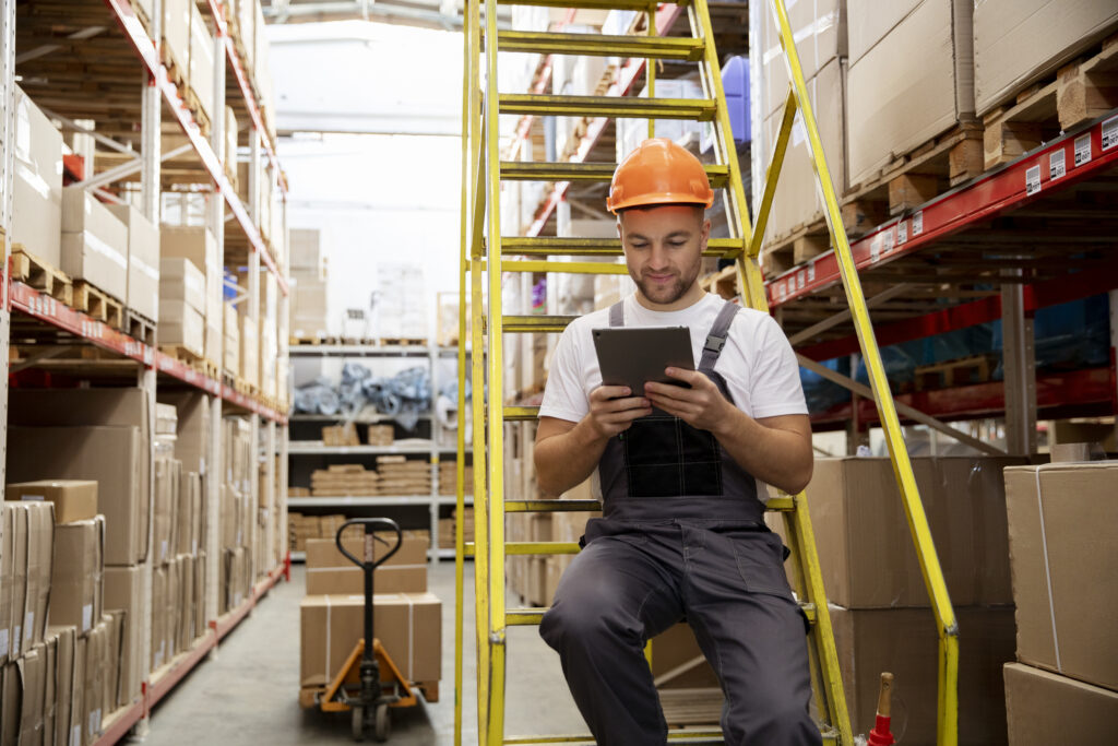 Warehouse worker doing automated order routing tracking 